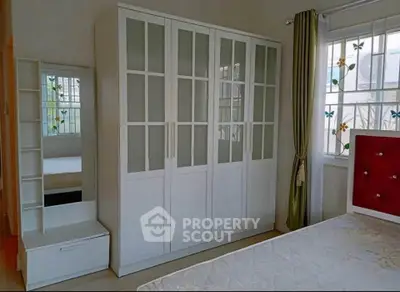 Bright bedroom with white wardrobe and elegant decor
