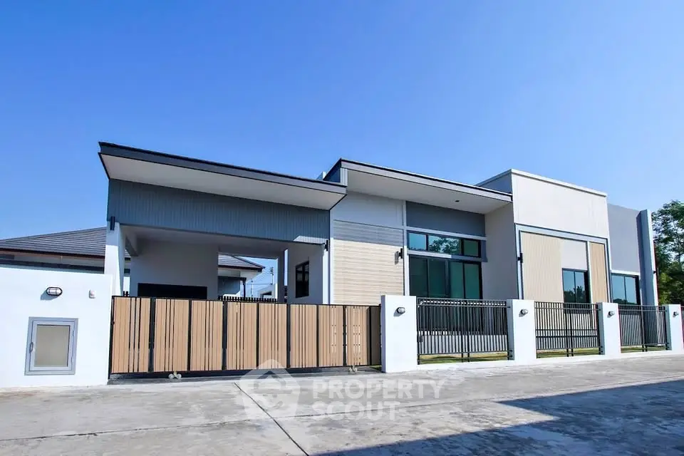 Modern luxury home exterior with sleek design and spacious driveway.