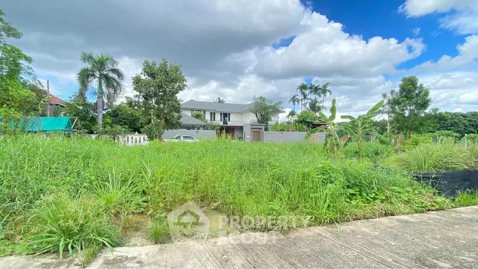 Spacious residential property with lush greenery and modern architecture under a vibrant sky.