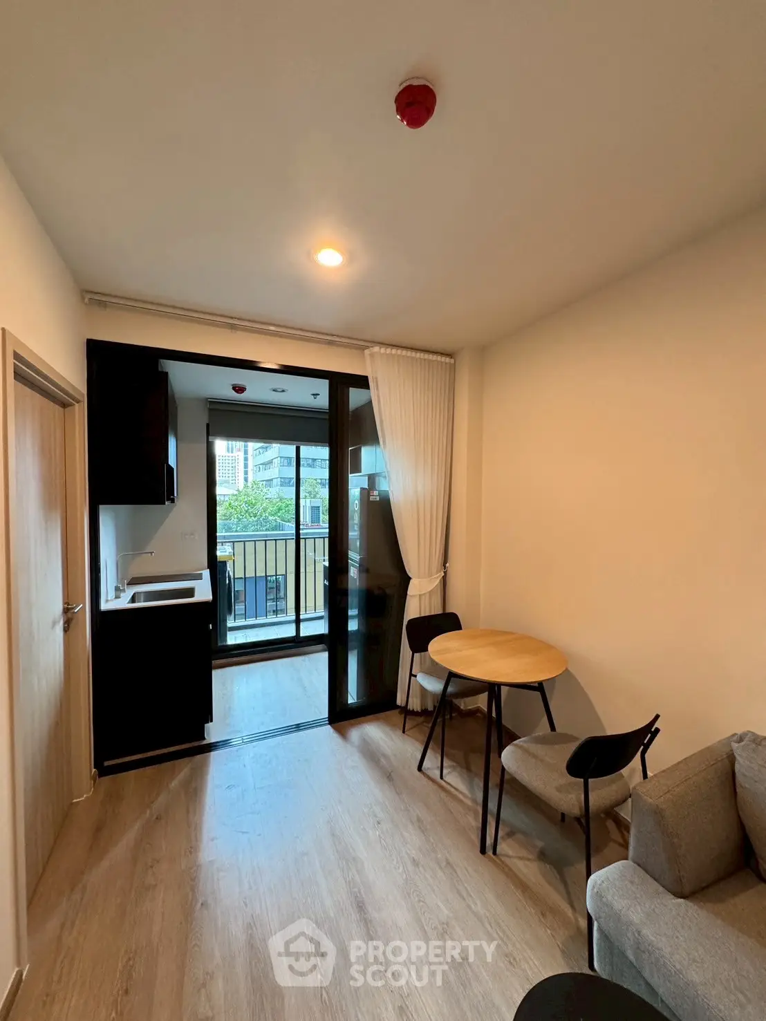 Modern apartment living room with balcony and kitchenette