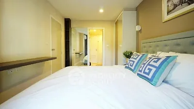 Spacious bedroom with modern decor and cozy ambiance, perfect for relaxation.
