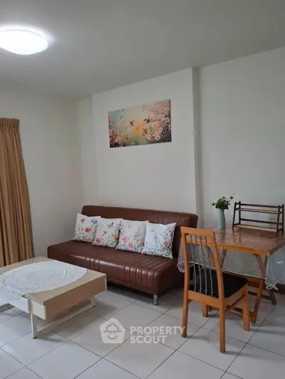 Cozy living room with stylish sofa and dining area, perfect for relaxation and entertaining.