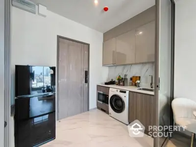 Modern kitchen with sleek appliances and marble flooring in a stylish apartment