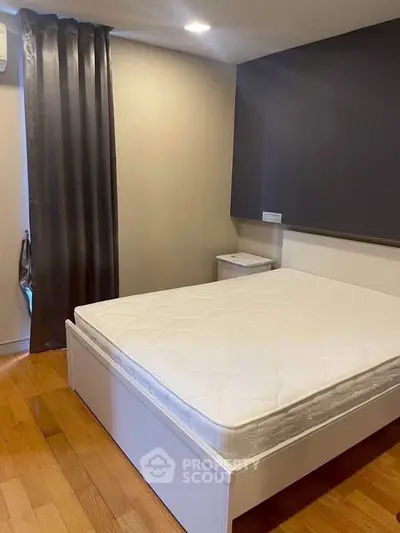 Modern bedroom with hardwood floors and sleek design