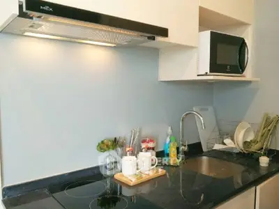 Modern kitchen with sleek black countertop and built-in appliances