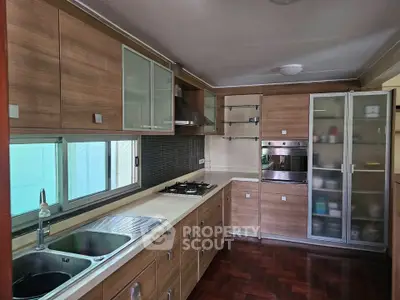 Modern kitchen with wooden cabinets and built-in appliances