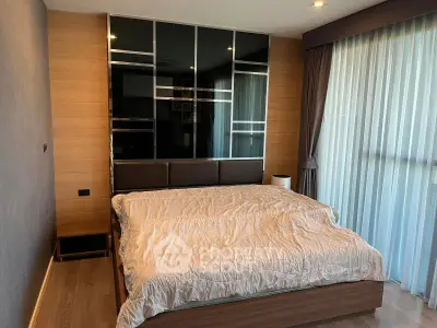 Modern bedroom with stylish decor and large window for natural light