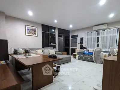Spacious living room with modern furniture and large windows for natural light.