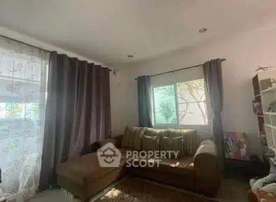 Cozy living room with large sofa and natural light