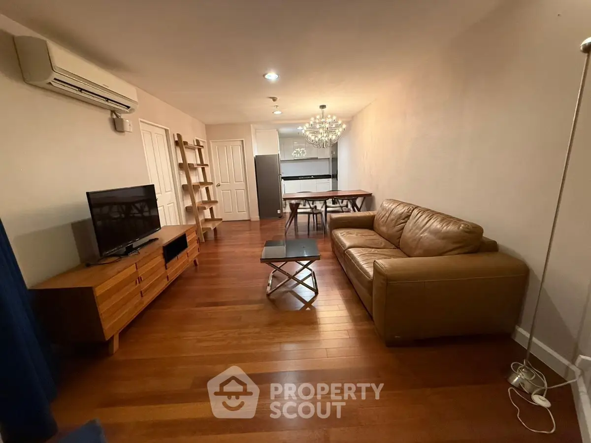 Spacious living room with modern furniture and elegant lighting, perfect for relaxation and entertainment.