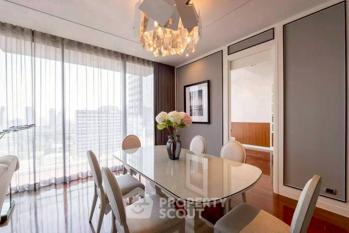 Elegant dining room with modern chandelier and city view, perfect for entertaining.