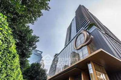 Stunning modern high-rise building with sleek glass facade and lush greenery.