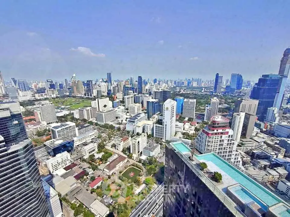 Stunning cityscape view from high-rise building with rooftop pool in vibrant urban area.
