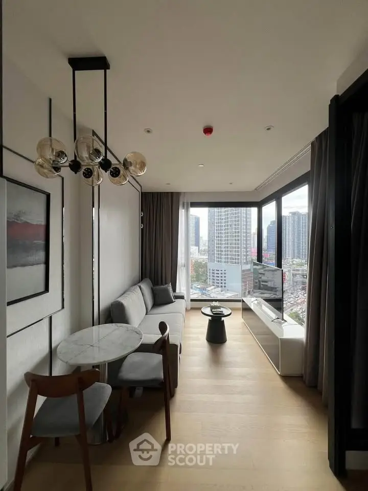 Modern living room with panoramic city view, stylish furniture, and elegant lighting in a high-rise apartment.