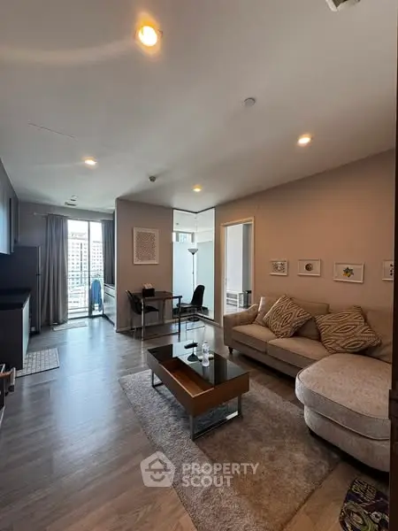 Modern living room with stylish furniture and city view, perfect for urban living.