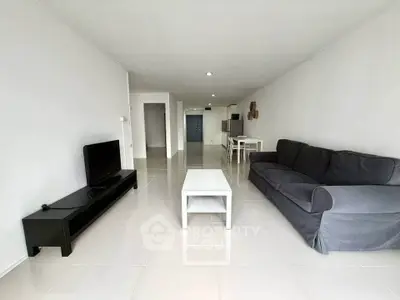 Spacious modern living room with sleek tile flooring and contemporary furniture.