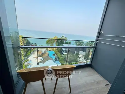 Stunning balcony with ocean view and cozy seating area