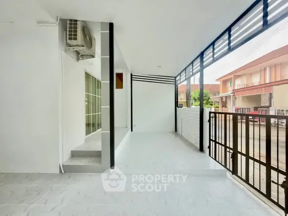 Spacious balcony with modern design and street view in a residential area.