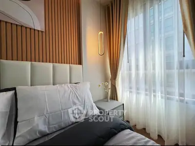 Modern bedroom with elegant decor and large window for natural light