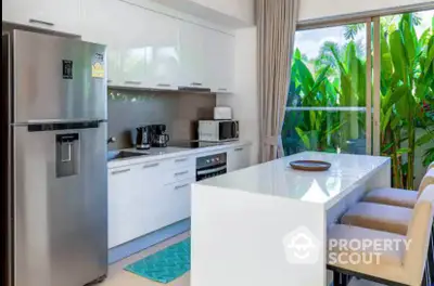 Modern kitchen with sleek white cabinetry and large window view