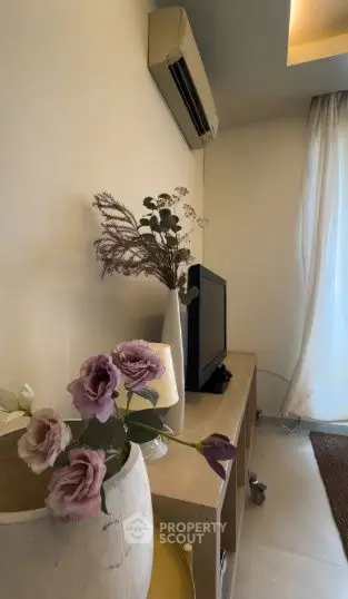 Cozy living room corner with TV and elegant floral decor