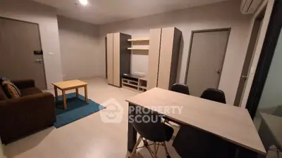 Modern living room with stylish furniture and dining area in open layout apartment.