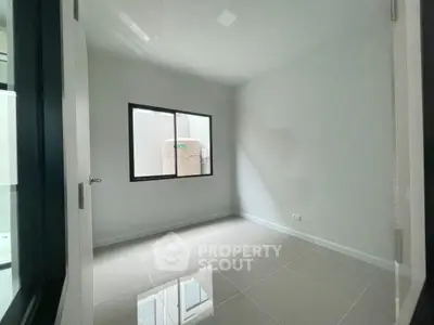 Minimalist empty room with glossy tiled floor and large window, perfect for customization.