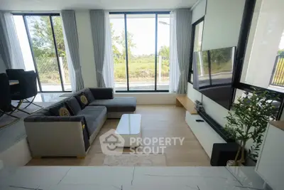 Spacious modern living room with large windows and stylish furniture