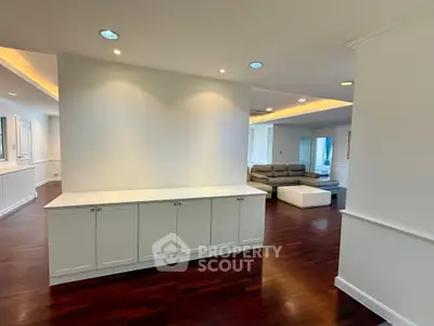 Spacious modern living room with elegant lighting and hardwood floors