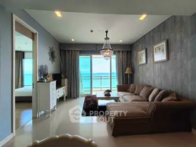 Luxurious living room with ocean view and elegant decor in modern apartment.