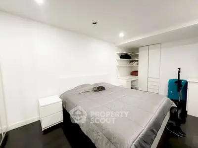 Spacious modern bedroom with sleek design and ample storage space.