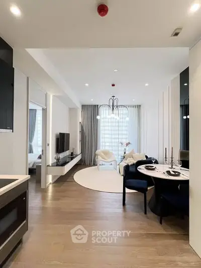 Modern open-plan living room with elegant dining area and stylish decor.