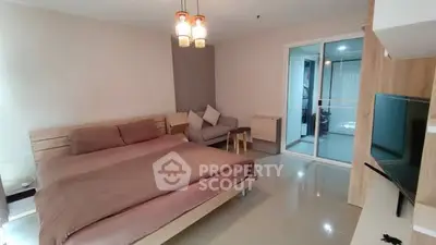 Spacious modern bedroom with cozy seating area and sleek design