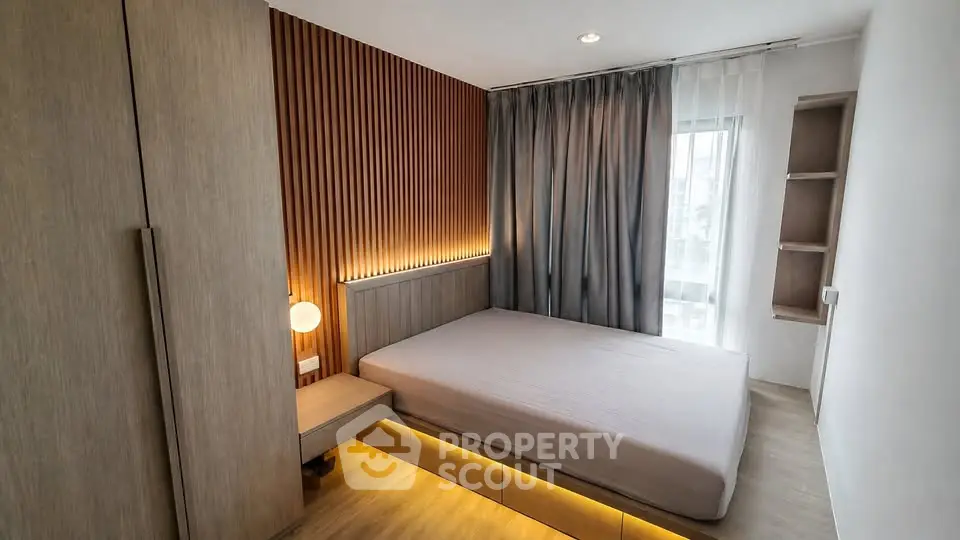 Modern bedroom with stylish wood paneling and ambient lighting