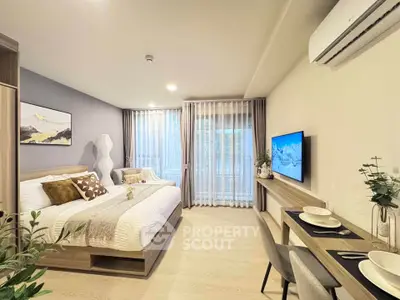 Modern bedroom with stylish decor and natural light, featuring a cozy bed and wall-mounted TV.