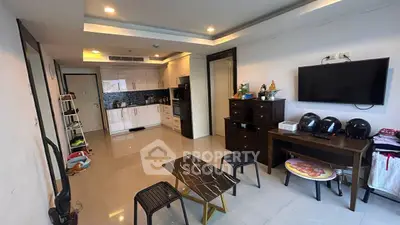 Modern living room with open kitchen and sleek furniture in a stylish apartment.