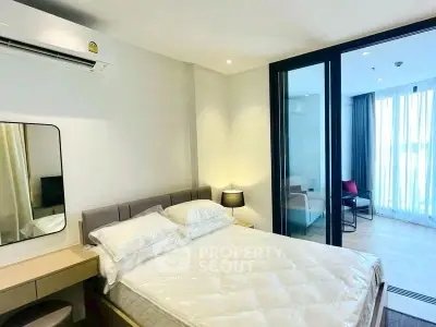 Modern bedroom with glass partition and cozy decor in a stylish apartment.