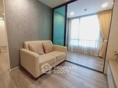 Modern living room with cozy sofa and large window with curtains, featuring elegant wooden flooring.