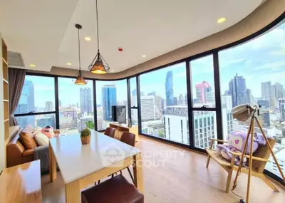 Stunning corner unit with panoramic city views and modern interior design in a high-rise building.