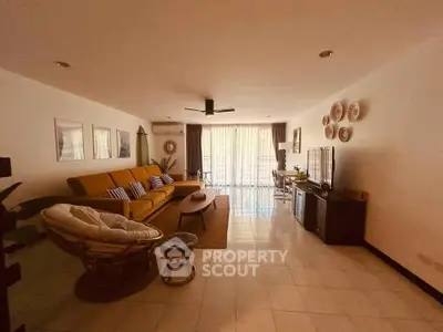 Spacious living room with modern decor and large windows for natural light