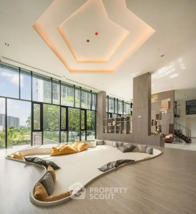 Luxurious modern living room with panoramic windows and unique sunken seating area.
