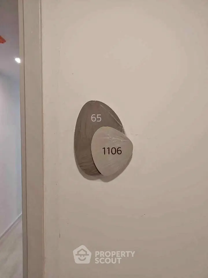 Modern apartment door with unique room number design, showcasing sleek and contemporary style.
