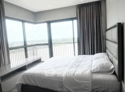 Spacious bedroom with large windows offering stunning views
