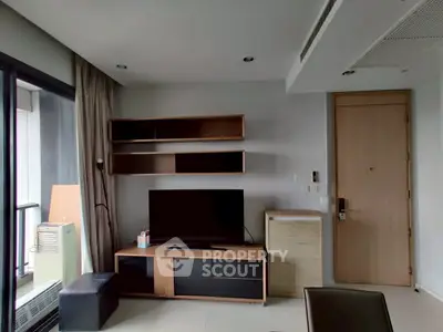 Modern living room with sleek furniture and balcony access in a stylish apartment.