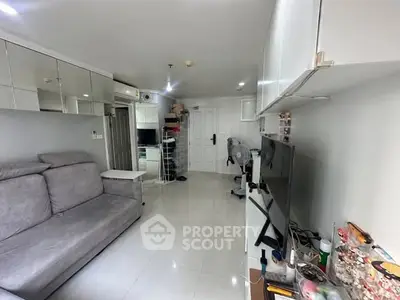 Modern living room with sleek design, featuring a comfortable sofa and wall-mounted TV.