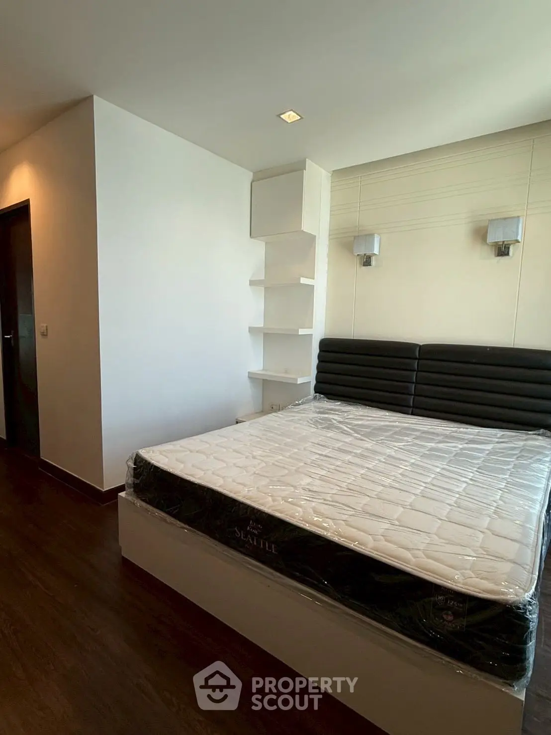 Modern bedroom with sleek design and built-in shelving