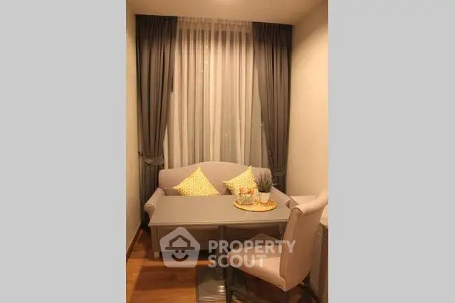 Cozy dining nook with elegant curtains and stylish seating in a modern apartment.