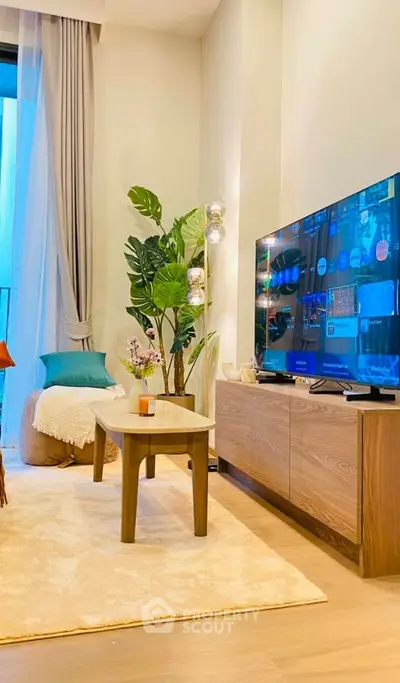 Modern living room with stylish decor, large TV, and cozy seating area, perfect for relaxation.