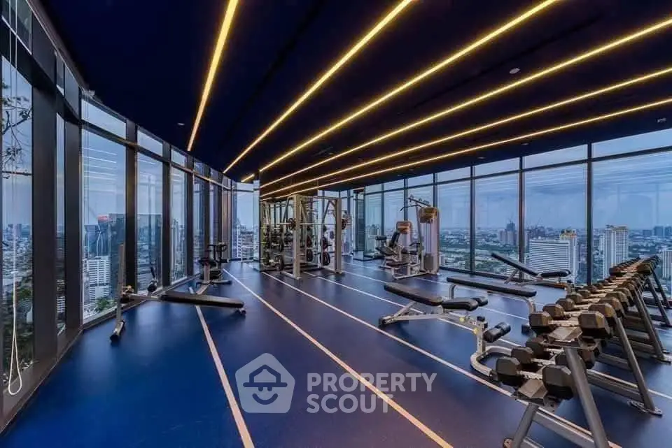 Luxury high-rise gym with panoramic city views and modern equipment.