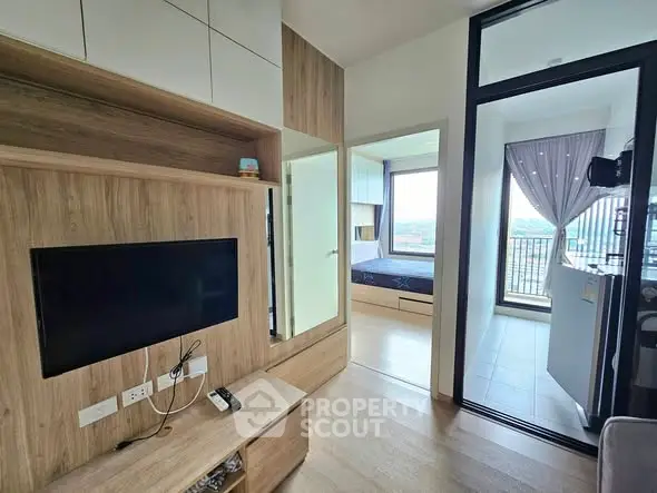 Modern apartment interior with cozy living area and bedroom view